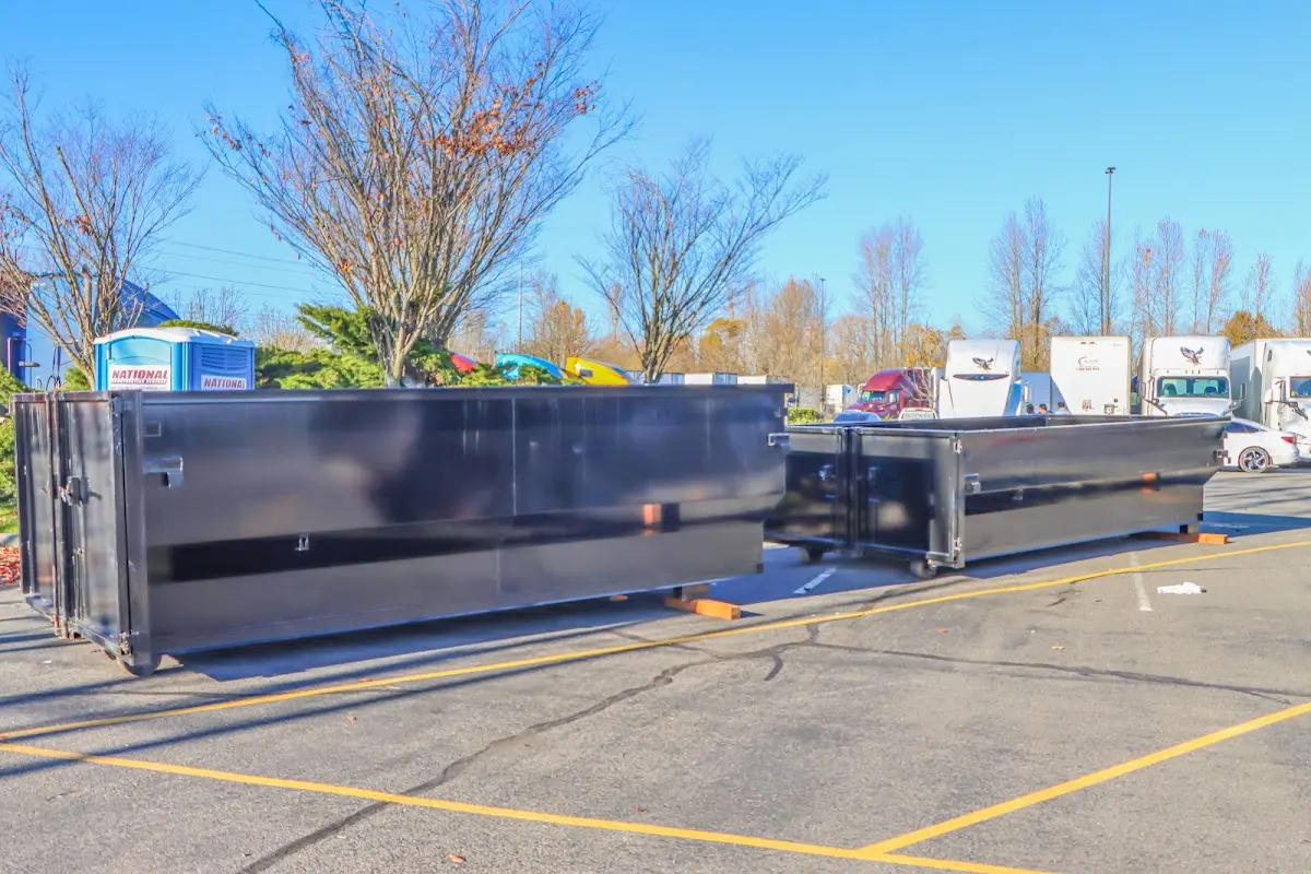 Professional dumpster rental service with roll-off container on residential driveway in Bethalto